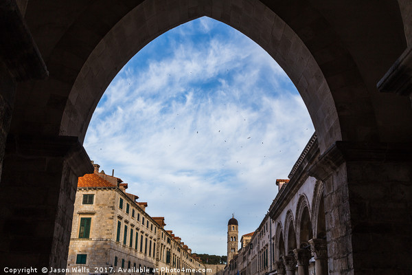The Stradun through an archway Picture Board by Jason Wells