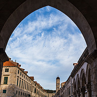 Buy canvas prints of The Stradun through an archway by Jason Wells
