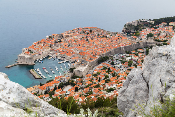 Dubrovnik seen between the rocks on Srd hill Picture Board by Jason Wells
