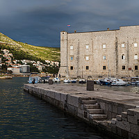 Buy canvas prints of Stormy skies behind St John’s Fortress by Jason Wells