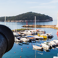Buy canvas prints of Cannon faces out over the harbour by Jason Wells