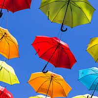 Buy canvas prints of Suspended umbrellas swaying in the wind by Jason Wells
