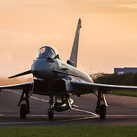 Buy canvas prints of Backlit Typhoon taxis out for takeoff by Jason Wells