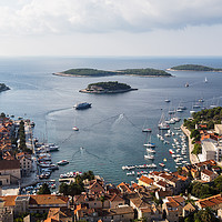 Buy canvas prints of Yacht-dotted inlet of Hvar old town by Jason Wells