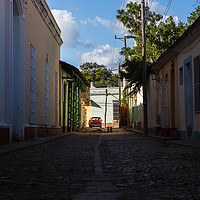 Buy canvas prints of Looking up a shady street in Trinidad by Jason Wells