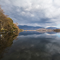 Buy canvas prints of Trees and mountains reflect in Derwent Water by Jason Wells