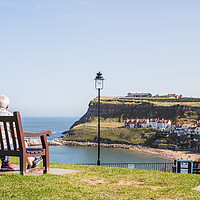 Buy canvas prints of Couple on a bench overlooking Whitby harbour by Jason Wells