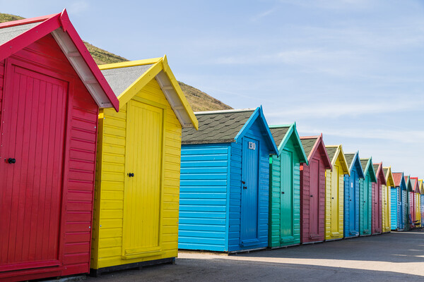 Pretty beach huts in Whitby Picture Board by Jason Wells