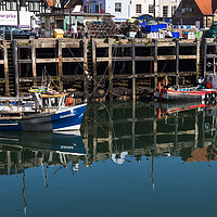 Buy canvas prints of Reflections of fishing boats by Jason Wells