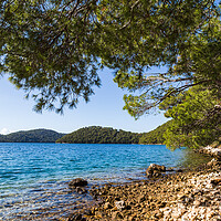Buy canvas prints of Rocky waterside in Mljet National Park by Jason Wells