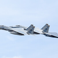 Buy canvas prints of Two F-15C Eagles with an F-15E Strike Eagle by Jason Wells