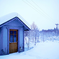 Buy canvas prints of A Blue Wooden Cabin on a Carpet of Fresh Snow  by Teresa Cooper