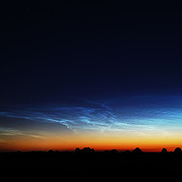 Buy canvas prints of Noctilucent clouds glow in the distance  by Teresa Cooper