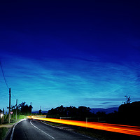 Buy canvas prints of Noctilucent clouds glow above the cars  by Teresa Cooper