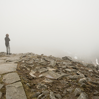Buy canvas prints of Woman standing in fog on peak by Arletta Cwalina