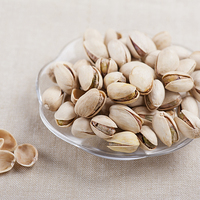 Buy canvas prints of pistachio nuts in shell lying on glass plate  by Arletta Cwalina