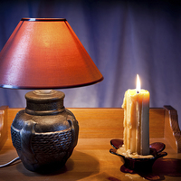 Buy canvas prints of electrical night light lamp and burning candle  by Arletta Cwalina
