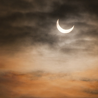 Buy canvas prints of Partial solar eclipse and clouds morning sky  by Arletta Cwalina