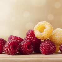 Buy canvas prints of ripe red and golden raspberry fruits by Arletta Cwalina