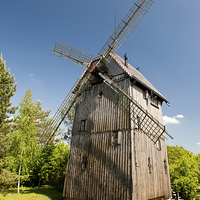 Buy canvas prints of Old wooden windmill building by Arletta Cwalina