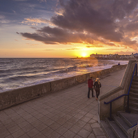 Buy canvas prints of   Couple enjoying the Porthcawl sunset by Dean Merry