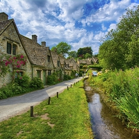 Buy canvas prints of  Cotswold stone cottages, Rack isle Bibury by Dean Merry