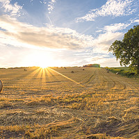 Buy canvas prints of Hay bales and the late day sun rays by Dean Merry