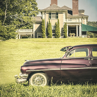 Buy canvas prints of Old classic car in front of large mansion by Edward Fielding