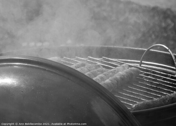 sausages on a barbecue in monochrome Picture Board by Ann Biddlecombe