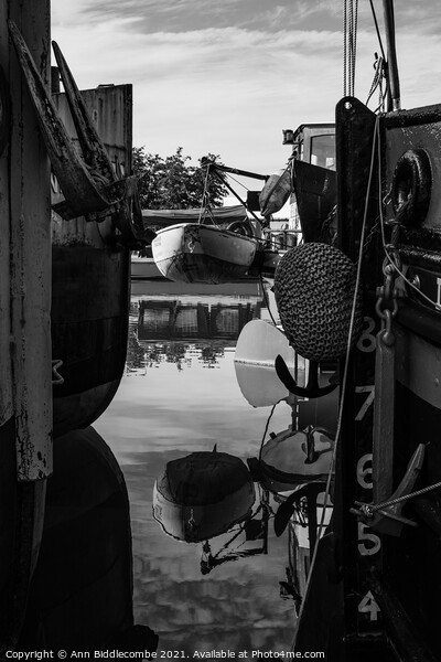 Reflections between barges in monochrome Picture Board by Ann Biddlecombe