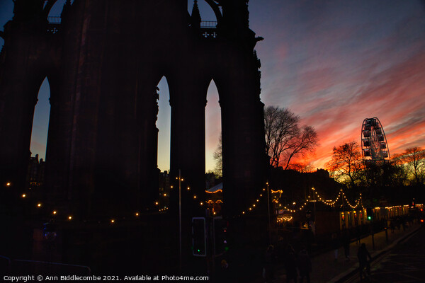 Sunset over Scott monument and big wheel in Edinburgh  Picture Board by Ann Biddlecombe