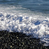 Buy canvas prints of Breaking on pebbles by Ann Biddlecombe