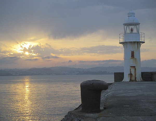  Brixham lighthouse by sunset Picture Board by Ann Biddlecombe