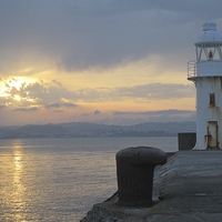 Buy canvas prints of  Brixham lighthouse by sunset by Ann Biddlecombe