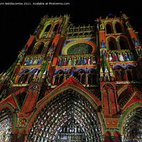 Buy canvas prints of Disguised in colorful lights is Amiens Cathedral by Ann Biddlecombe