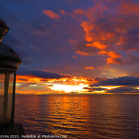 Buy canvas prints of Sunset over the Lagoon with an old lantern by Ann Biddlecombe