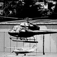 Buy canvas prints of Helicopter hovering in Monochrome by Ann Biddlecombe