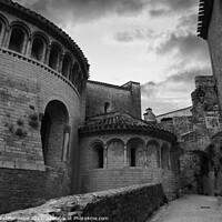 Buy canvas prints of A street in Saint-Guilhem-le-Désert in black and white by Ann Biddlecombe