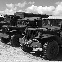 Buy canvas prints of Military trucks and jeeps on Weymouth beach in mon by Ann Biddlecombe