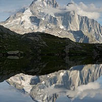 Buy canvas prints of The Dru reflected in Lac des Cheserys by Stephen Taylor