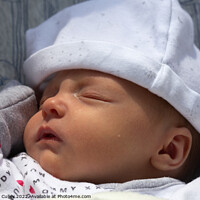 Buy canvas prints of Sleeping newborn baby wearing sleepsuit and hat by Gregory Culley