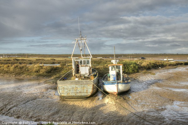 Low tide boats at Brancaster Picture Board by Sally Lloyd