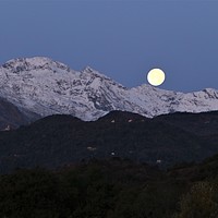 Buy canvas prints of Moon setting behind the mountains before sunrise by Fabrizio Malisan