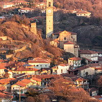 Buy canvas prints of Afternoon sunlight over the village town and churc by Fabrizio Malisan