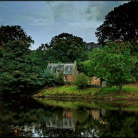Buy canvas prints of "STORM CLOUDS GATHER OVER THE RIVERSIDE COTTAGE" by ROS RIDLEY