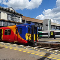 Buy canvas prints of SWR Train at Clapham Junction  by John Bridge