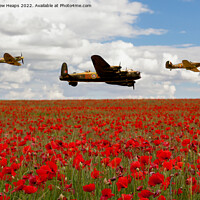 Buy canvas prints of Flying bomber and spitfire planes over poppy field by Andrew Heaps