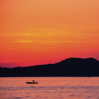 Buy canvas prints of  Croatian fishing Boat Sunset by William Duggan