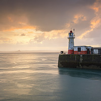 Buy canvas prints of Newlyn Lighthouse at sunrise by Andrew Ray