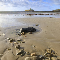 Buy canvas prints of Rocks on St Cwyfan's Church Beach by Andrew Ray